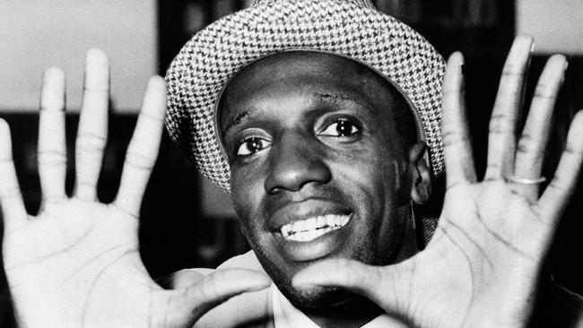 FILE - In this May 17, 1959, file photo, Meadowlark Lemon, of the Harlem Globetrotters, shows off his large hands on arrival in London where the team was to perform at the Empire Pool in Wembley for a week. Lemon, known as the Globetrotters' "clown prince" of basketball, died Sunday, Dec. 27, 2015, in Scottsdale, Ariz. He was 83. (AP Photo/File)