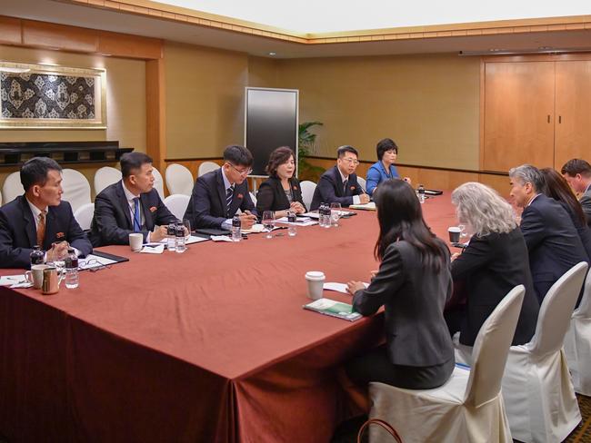 In this photo released by the US State Department, members of the North Korean delegation meet with members of the US delegation.