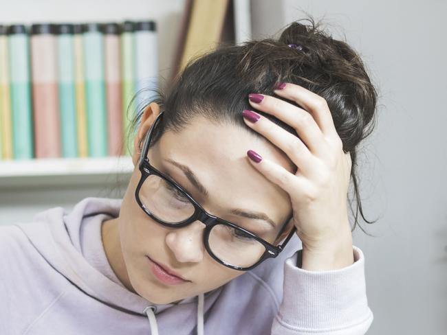 Stressed student  Doing  Homework At The Desk