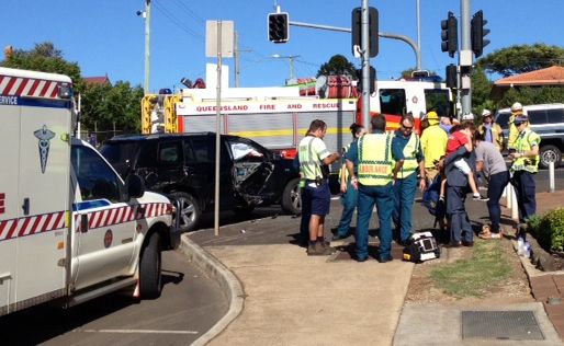 Emergency services at the scene of a collision between a black 4WD and bus at the intersection of Herries and Cohoe Sts this morning.