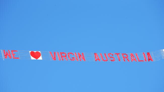 A light aircraft with the banner 'We Love Virgin Australia' flew over Brighton Beach in support of the airline which has been forced into voluntary administration. Picture: Ian Currie