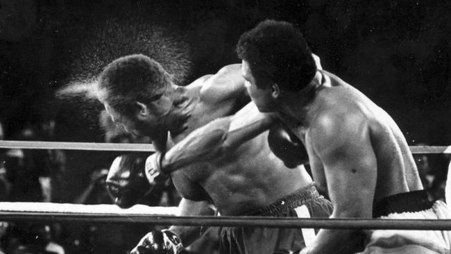 Perspiration flies from the head of George Foreman as he takes a right from Muhammad Ali in the seventh round of the Rumble in the Jungle in 1974. Picture: Ed Kolenovsky/AP