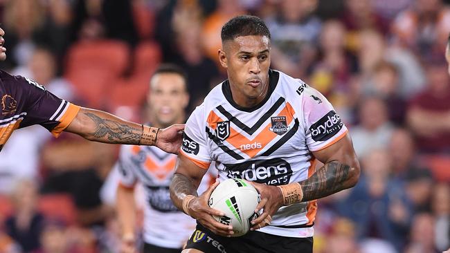 Michael Chee Kam of the Tigers (centre) on his way to scoring the winning try in the Round 5 NRL match between the Brisbane Broncos and the Wests Tigers at Suncorp Stadium in Brisbane, Thursday, April 11, 2019. (AAP Image/Dave Hunt) NO ARCHIVING, EDITORIAL USE ONLY