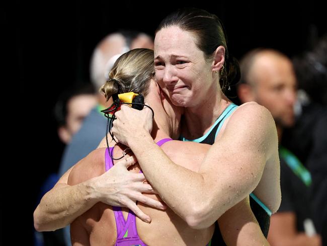 Cate Campbell (R) hugs her sister Bronte Campbell after competing in the women’s 50m freestyle heats during the Australian Swimming Trials in Brisbane. Picture: AFP