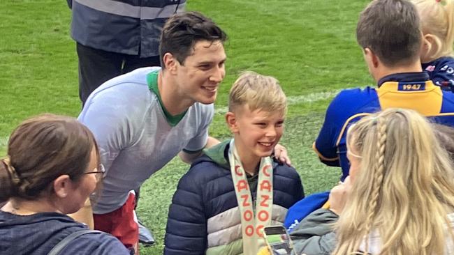 Lebanon star Mitchell Moses gives his man of the match medal to a young fan.