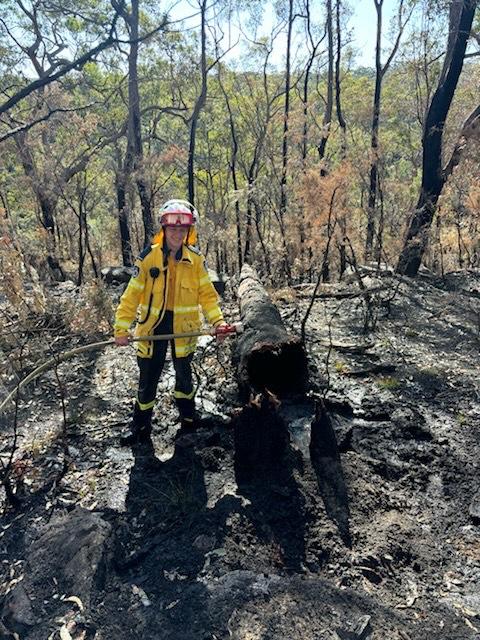 Flyn Morgan from the Grose Vale RFS Brigade extinguishing a relit hazard reduction burn. Picture: Supplied