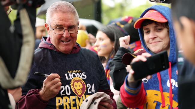 Lions coach Chris Fagan signs autographs with fans at Brunswick Street Oval in Fitzroy on Sunday. Picture Lachie Millard