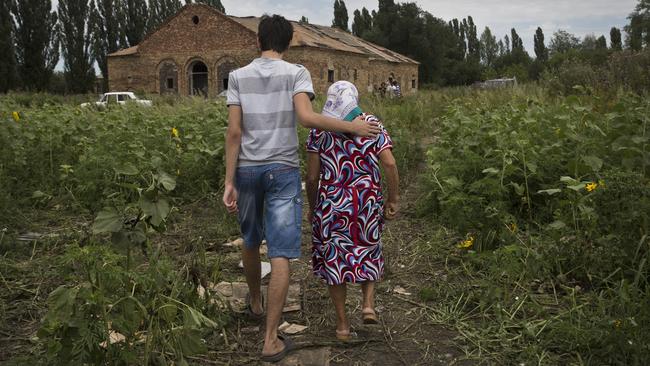 Bereft locals from the village of Rozsypne who witnessed bodies falling from the sky. Picture: Ella Pellegrini