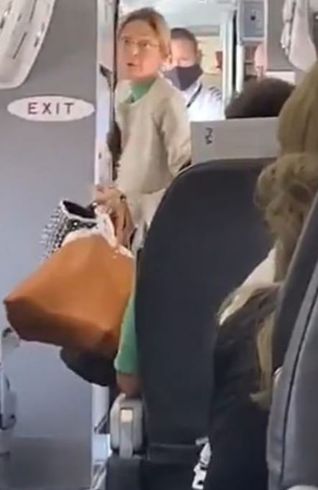 The woman yells at passengers as she’s removed from the plane. Picture: TikTok/Jordan Slade