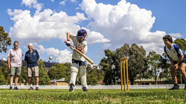 Passionate former cricketers Peter Morley, 78, rear, left, and Rob Asquith, 80, watch on with pride and joy at the oval they have lovingly restored at Euroa in rural Victoria. Picture: Aaron Francis