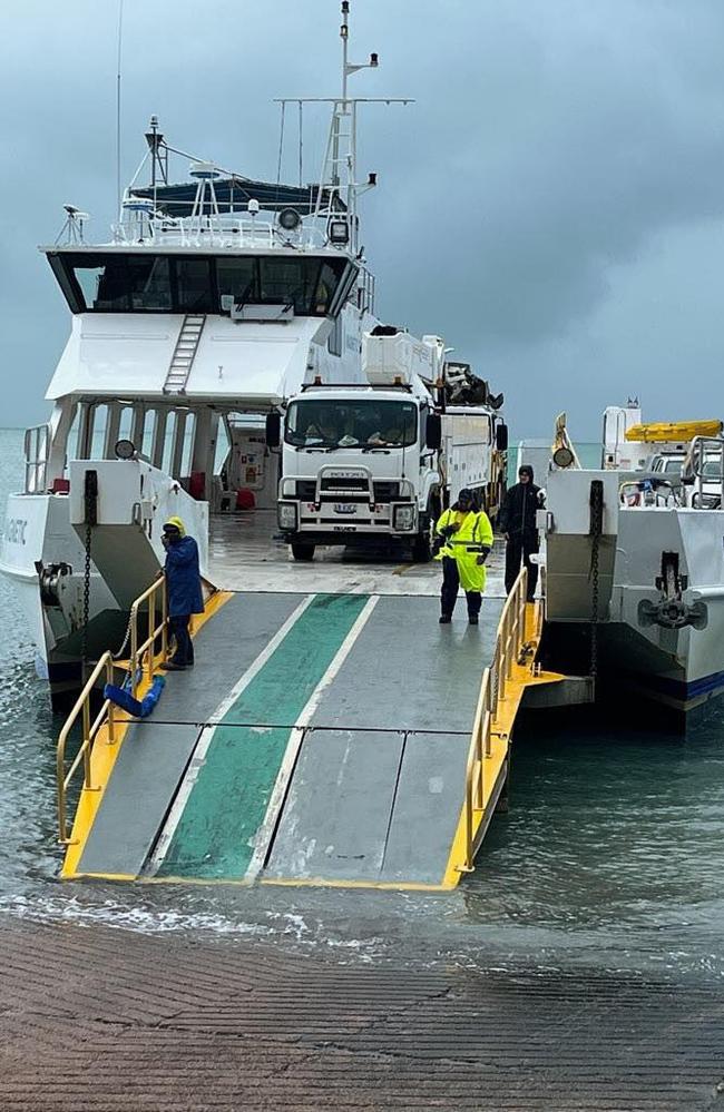 Ergon crews arrive on the barge to Palm Island to restore services after days of intense rainfall and wind. Picture: Palm Island Aboriginal Shire Council.