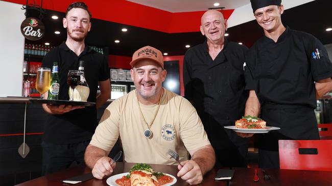 Head bartender Aaron Bull, co owner Shane Shroj, head chef Peter Batrachenko and apprentice chef Justin Allen serve up some beer, chianti and a large helping of lasagne at the new restaurant on the corner of Sheridan and Shields Streets. Picture: Brendan Radke