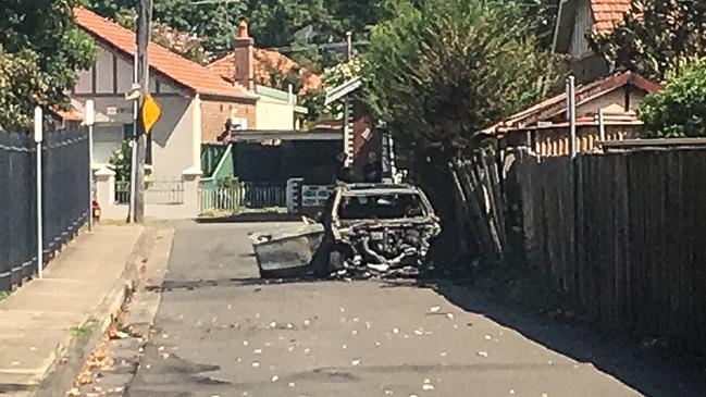 A burned out car believed to be involved in the Rockdale Fitness First shooting. Picture: Nick Hansen