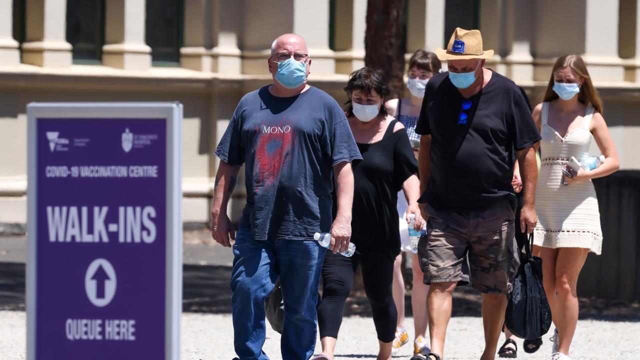 People line up for their booster vaccination at the Royal Exhibition Building. Picture: NCA NewsWire / Ian Currie