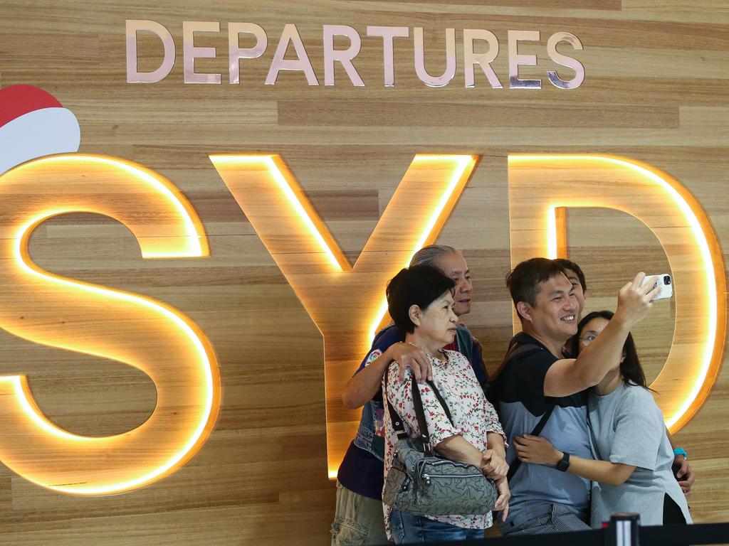 SYDNEY, AUSTRALIA - Newswire Photos JANUARY 02, 2022: People are seen at the Sydney International Airport departures terminal taking a selfie, after Australia set new Covid entry rules for travellers entering the country from China. The government is reportedly considering testing plane waste water on affected flights also. Picture: NCA Newswire / Gaye Gerard