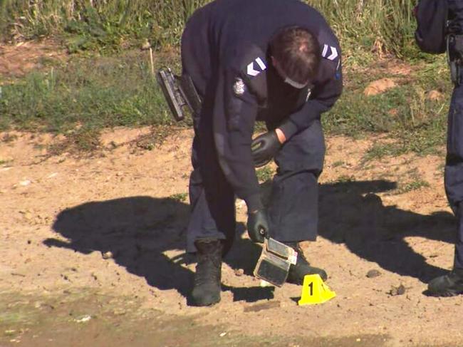 Police with the phone found in Wednesday’s search. Picture: 9News