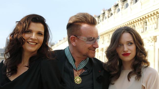 Bono, lead singer of Irish rock band, U2, poses with his wife Ali and daughter Eve Hewson after receiving the Commander of the Order of Arts and Letters. Picture: AFP