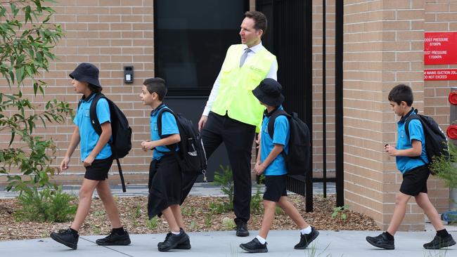 Gulyangarri Public School principal Ian Tapuska guides displaced students to their new temporary school. Picture: Rohan Kelly