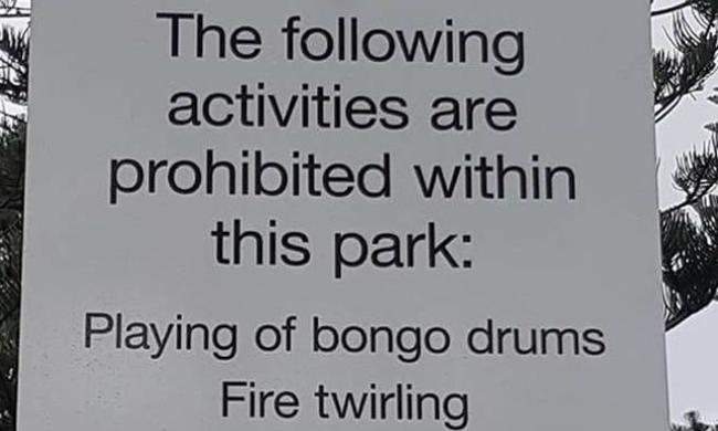 Burleigh locals are outraged after a sign banning bongo drums and fire twirlers popped up in the park. Photo: Facebook