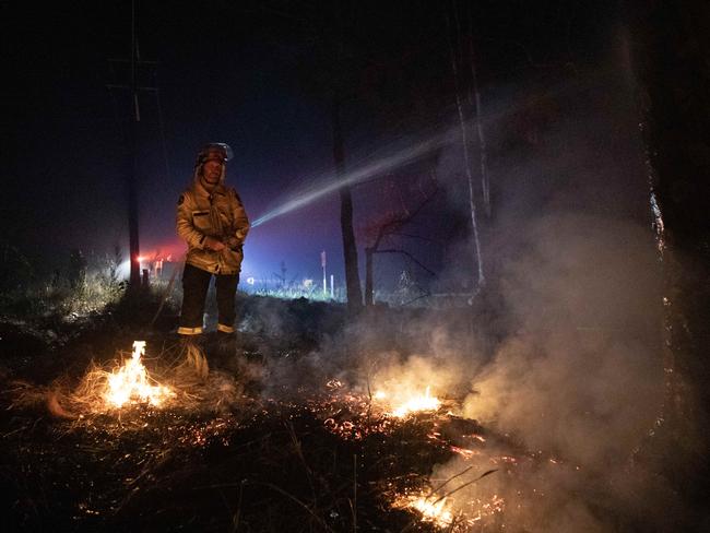 04-10-2023 - Firefighter Grant Clark from Tilba works to control a bushfire on the NSW south coast on Wednesday morning - the first major bushfire since the Black Summer bushfires of 2019-2020 raged through the Bega region. Picture: Liam Mendes / The Australian