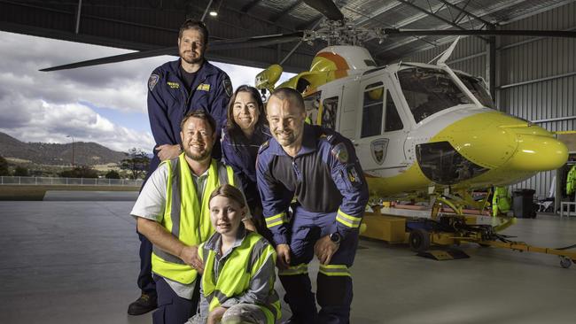 Rotorlift Rescue Pilot Thomas Gorczynski, Patient Kieran Harrison with his daughter Maisie, aged 10, and Ambulance Tasmania Emergency physician retrieval consultant Dr Anke Barta and intensive care flight paramedic Andy Summers. Picture: Linda Higginson