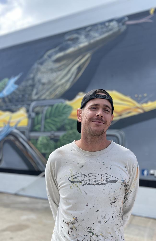 Gwada Murals artist Martin Jegou in front of the huge goanna mural at the new Goanna Brewing venue at 2c Victoria St in 2024. Photo: Zoe Devenport