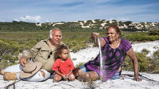 Guugu Yimithirr elders Richard and Lillian Bowen play with grandson Hunter at the silica sands of their threatened ancestral Dharrba country north of Hopevale. Picture: Brian Cassey