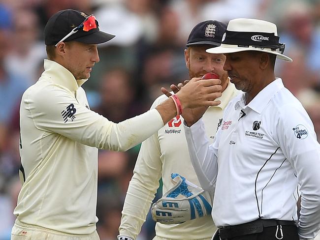 BIRMINGHAM, ENGLAND - AUGUST 04: England captain Joe Root holds up the ball for umpire Joel Wilson to smell during day four of the 1st Specsavers Ashes Test between England and Australia at Edgbaston on August 04, 2019 in Birmingham, England. (Photo by Gareth Copley/Getty Images)