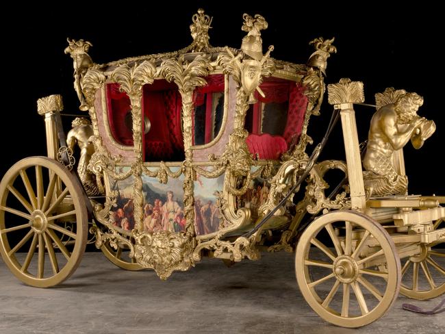 The Gold State CoachA reproduction inspired by the 1760 commission by Francis Rawdon-Hastings, 1st Marquess of Hastings for King George III, and designed by Sir William Chambers, approximately: 188cm wide, 560cm deep, 315cm high (74in wide, 220in deep, 124in high)