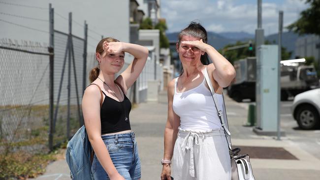 Sonia Hansen, 14, and her mother Alison Watson of Trinity Beach walk along a hot and sunny section of footpath on Spence Street. Picture: Brendan Radke