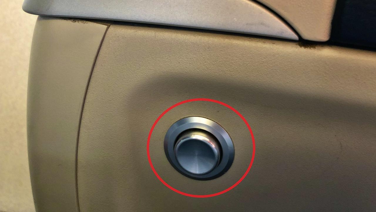 Push button for seat recline on airplane