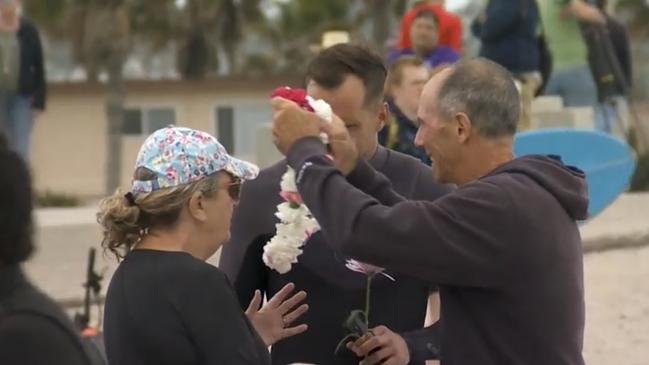 Debra and Martin Robinson, the parents of Callum and Jake Robinson, at the paddle out in honour of their sons. Picture: Nine News