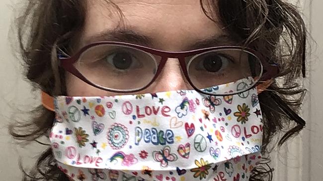 A Belgian woman wears a mouth mask, meant to help protect from the spread of COVID-19, that she produced on her sewing machine at home. (Anais Moyson via AP)