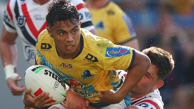 GOLD COAST, AUSTRALIA - AUGUST 25: Keano Kini of the Titans is tackled during the round 25 NRL match between Gold Coast Titans and Sydney Roosters at Cbus Super Stadium, on August 25, 2024, in Gold Coast, Australia. (Photo by Chris Hyde/Getty Images)