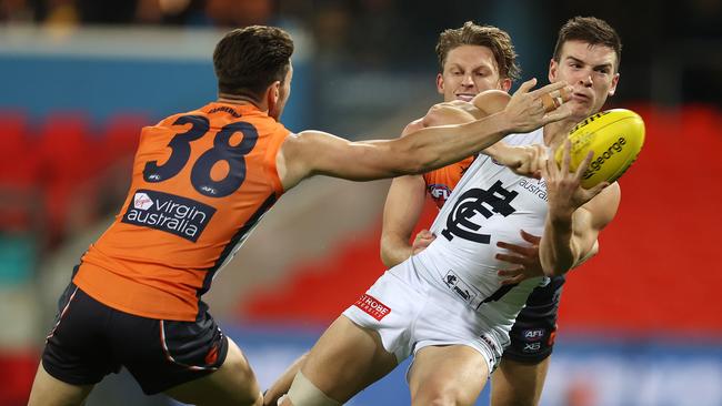 Paddy Dow of the Blues clears under pressure. Picture: Michael Klein