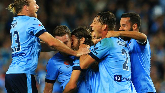 Josh Brillante is mobbed by teammates after opening the scoring.