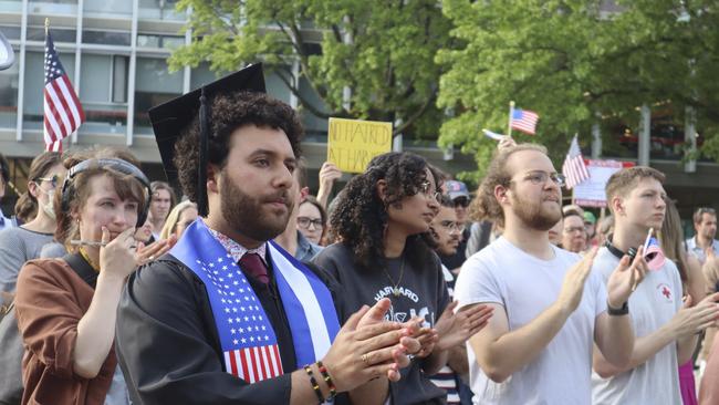 Harvard University graduating senior Victor Flores claps while listening to a fellow student speak. Picture: AP