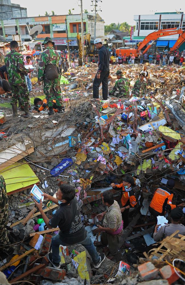 Indonesian members of search and rescue team look for survivors amongst the rubble of collapsed buildings after a 6.5 Magnitude earthquake in Pidie Jaya, Aceh province. Picture: AFP