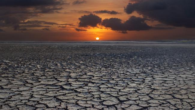 global warming. dramatic sky over cracked earth