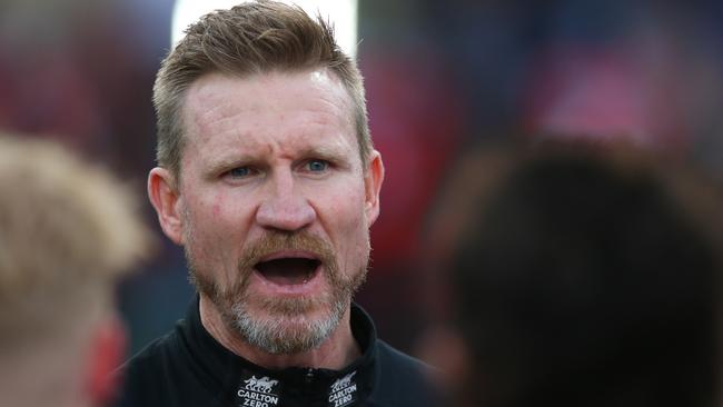 Nathan Buckley speaks to his players in his last match as senior coach.