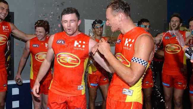 Will Brodie and Pearce Hanley of the Suns are sprayed with gatorade as they celebrate victory after the round 11 AFL match between the Gold Coast Suns and the West Coast Eagles at Metricon Stadium (Photo by Bradley Kanaris/Getty Images)