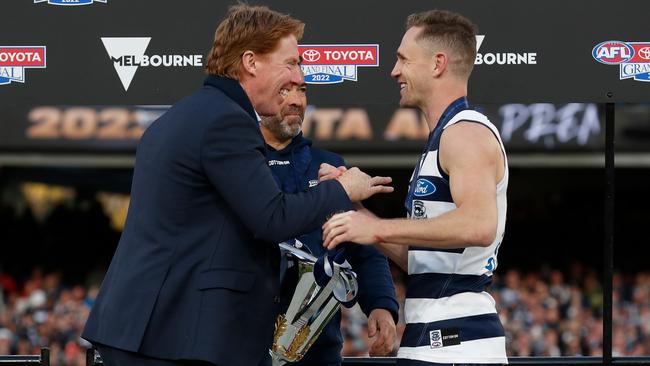 MELBOURNE, AUSTRALIA - SEPTEMBER 24: Cameron Ling presents the Cup to Chris Scott, Senior Coach of the Cats and Joel Selwood of the Cats during the 2022 Toyota AFL Grand Final match between the Geelong Cats and the Sydney Swans at the Melbourne Cricket Ground on September 24, 2022 in Melbourne, Australia. (Photo by Michael Willson/AFL Photos via Getty Images)