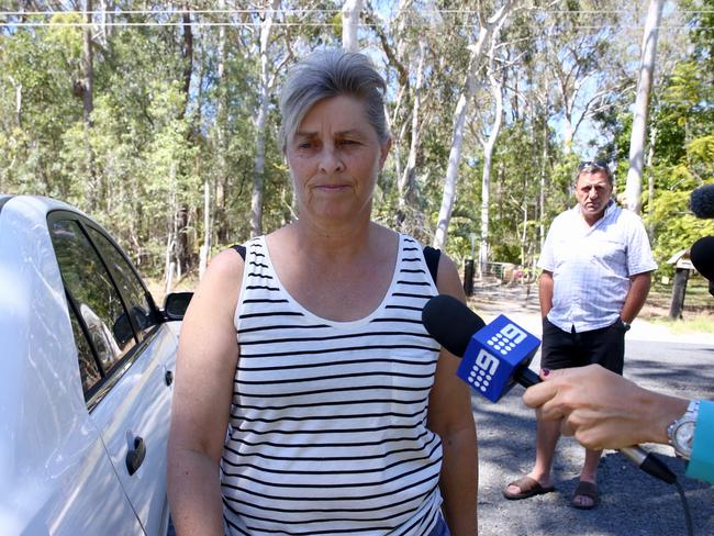 Julene fed her horses as forensic police searched their rural property. Picture: Liam Kidston