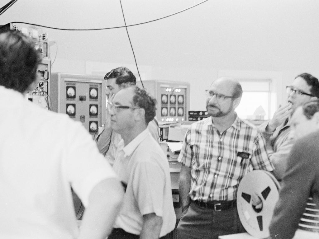 The team inside the control room at The Dish, including David Cooke, right, watch the Moon landing in amazement in 1969. Picture: David Cooke