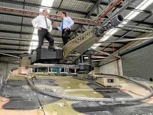 Rheinmetall Defence managing director Gary Stewart and Cameron Dick MP get a close look at the Boxer CRV at Wacol on Thursday.