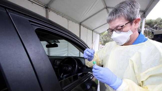 A nurse takes a sample from a driver at a COVID-19 drive-through testing facility at Hampstead Rehabilitation Centre in Adelaide. Picture: AAP