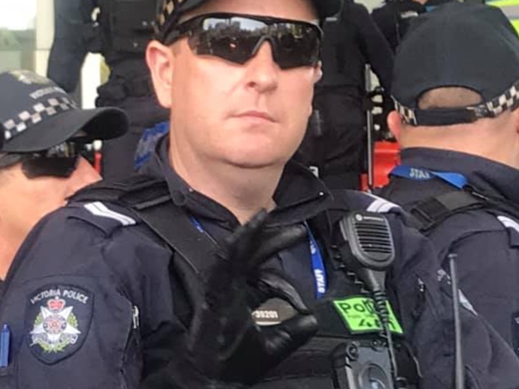 A Victoria Police officer gives the 'OK' salute.