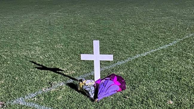 A cross and flowers are laid on Gumeracha Oval to honour Antonio Loiacono. Picture: Facebook