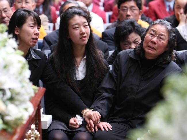 Brenda Lin endures the heartache of the funerals of her family members along with relatives in 2009. Picture: Getty