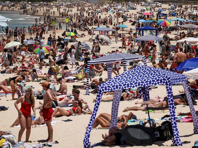 Beachgoers are seen on the sand on Christmas Day at Bondi Beach in Sydney on December 25, 2024. (Photo by DAVID GRAY / AFP)